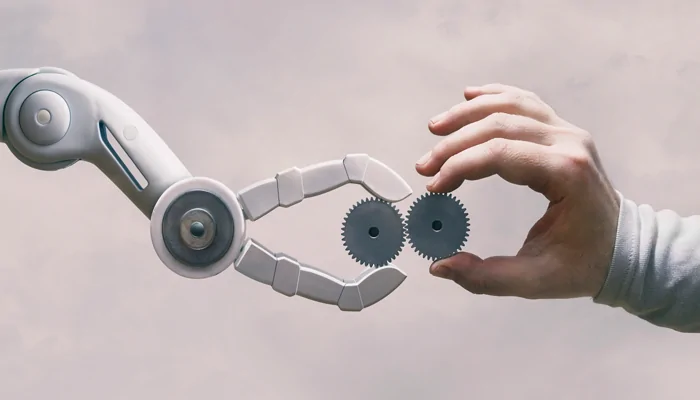 robotarm neemt tandwielen van menselijke hand
